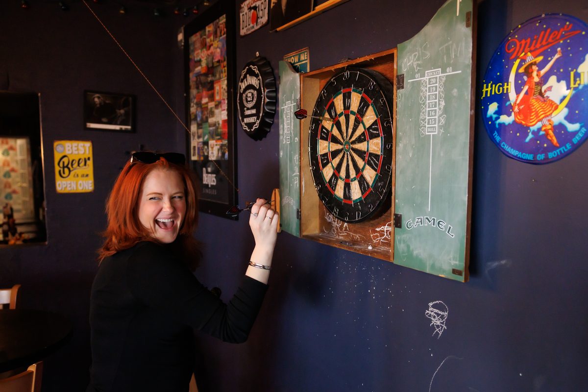 Darts player having fun at The Locals Pub