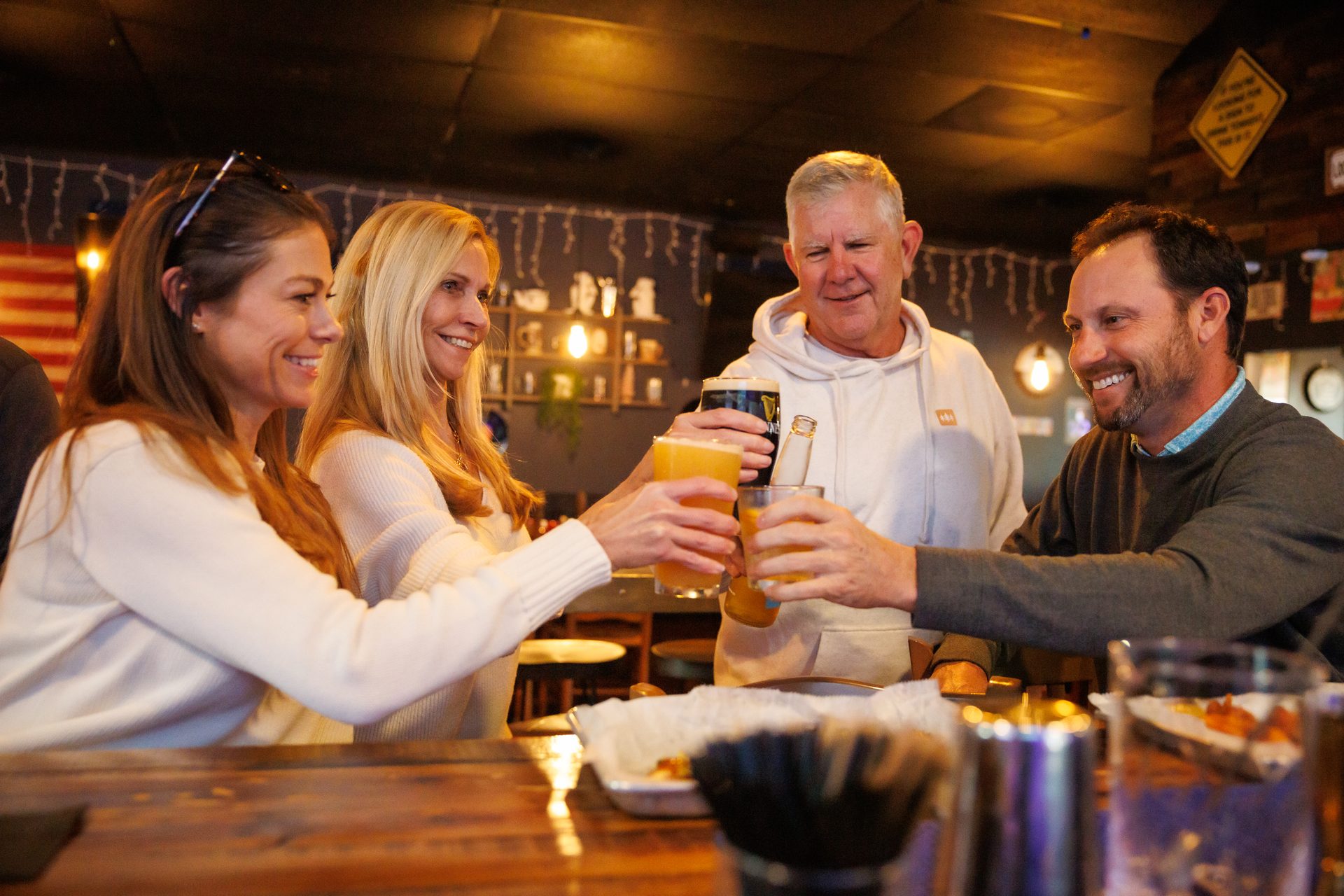 Friends cheering at The Locals Pub - Tequesta community bar